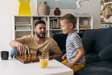 Wall Mural - father playing chess with his son at home