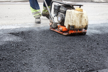 asphalt rammer. laying the road surface