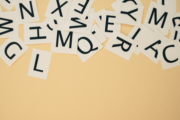 Sticker - Top view of scattered English letters on brown background