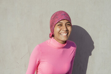 Young woman with cancer showing hope in her smile. Hope, Struggle, Empowerment Concept.