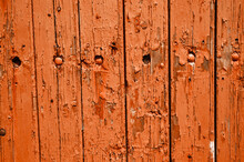 Texture Of Weathered Wooden Lining Boards With Peeling Orange Paint And Rusty Nail Heads.
