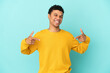 Young African American man isolated on blue background proud and self-satisfied