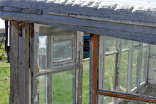 An Old Greenhouse Of Rotten Windows With Cracked Paint