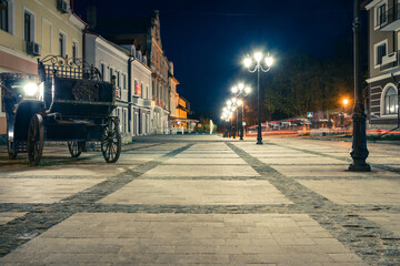 Poster - Beautiful road at night in the old part of the city.Night boulevard lined with tiles with street lamps in the historical part of the city of Kamianets-Podilskyi. Ukraine.