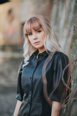 Poster - Attractive Caucasian blonde female wearing a stylish leather dress posing for a fashion photoshoot