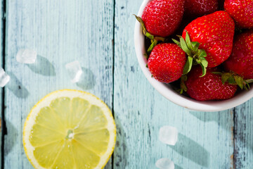 Wall Mural - strawberry jam ingredients on blue wooden table, top view