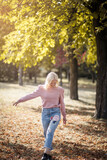 Fototapeta Przestrzenne - Happy young woman walking trough park.