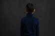 portrait from behind guy caucasian teenager on gray background
