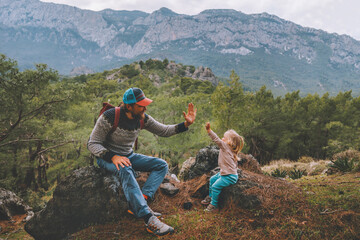 Wall Mural - family father and child daughter high five hands traveling in mountains hiking together summer vacat
