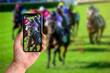 © PicMedia - Man taking photo of horse racing