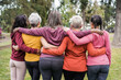 © DisobeyArt - Back view of multi generational women hugging each others outdoors in city park - Focus on african woman head