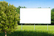 © Francesco Scatena - Blank advertising billboard immersed in a rural scene with blurred tree in the foreground - concept image with copy space