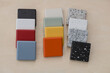 Colourful natural stone kitchen worktop samples on wooden background.