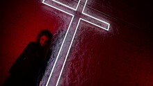 A Demon Has Taken Possession Of The Girl Body A Horror Scene Against The Background Of A Large Neon Cross. Artistic Image For Halloween.