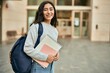 © Krakenimages.com - Young middle east student girl smiling happy holding book at the city.