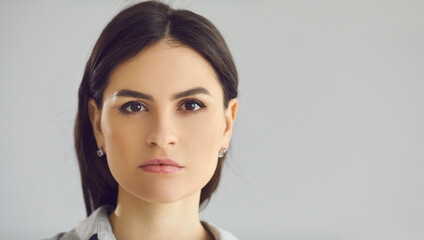 Portrait of serious confident successful ambitious driven modern European feminist woman looking ahead. Banner, studio close up headshot. Women's rights, face skincare, good sight, eyesight concept