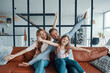 © gstockstudio - Playful young family stretching out their hands