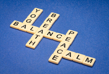 Poster - yoga, balance, breath, peace and calm  crossword in ivory letter tiles against textured paper, exercise and lifestyle concept