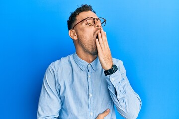 Poster - Young hispanic man wearing casual clothes and glasses bored yawning tired covering mouth with hand. restless and sleepiness.