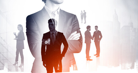 Wall Mural - Businessman with arms crossed and business people double exposure with buildings