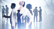 © ImageFlow - Silhouettes of diverse business people working, rushing and looking for solutions in abstract office space with skyscraper city view. Business development concept. Double exposure