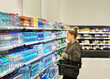 © lado2016 - Woman  Buying a bottle of water in a supermarket