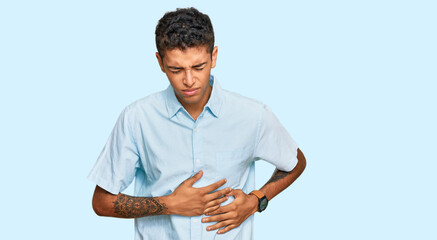 Sticker - Young handsome african american man wearing casual clothes with hand on stomach because indigestion, painful illness feeling unwell. ache concept.