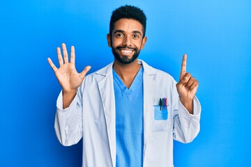 Wall Mural - Handsome hispanic man with beard wearing doctor uniform showing and pointing up with fingers number six while smiling confident and happy.