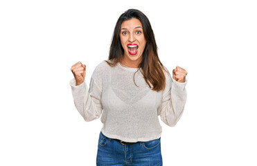 Sticker - Beautiful hispanic woman wearing casual sweater celebrating surprised and amazed for success with arms raised and open eyes. winner concept.