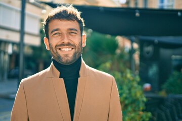 handsome business man wearing elegant jacket smiling happy outdoors