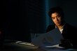© CandyRetriever  - Stressed Asian businessman office worker working overtime alone in modern office at night. Tired overworked business man working on desktop computer for success business project plan strategy at night