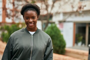 Poster - Young african american girl smiling happy standing at the city.