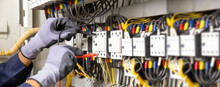 Electrician Engineer Tests Electrical Installations And Wires On Relay Protection System. Adjustment Of Scheme Of Automation And Control Of Electrical Equipment.