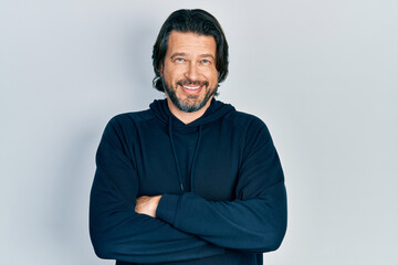 Middle age caucasian man wearing casual sweatshirt happy face smiling with crossed arms looking at the camera. positive person.