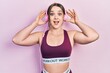 © Krakenimages.com - Young hispanic girl wearing gym clothes and using headphones celebrating crazy and amazed for success with open eyes screaming excited.