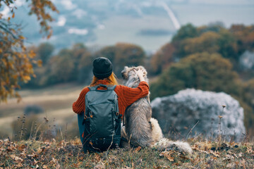 woman hiker dog outdoors in the mountains travel vacation