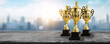 1st champion award, the best prize and winner concept, championship cup or winner trophy on wood table with soft blue and bokeh city background.