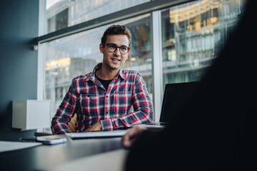 Young businessman sitting in a meeting