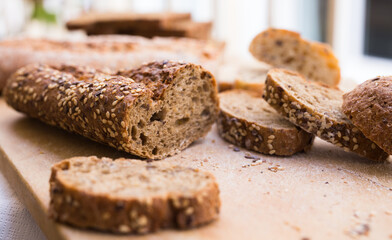 Wall Mural - fresh loaf of bread on wooden board