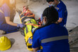 © ME Image - Paramedic woman and team first aid builder accident in site work. Team EMS paramedic first aid for head injuries. Employee accident in construction site work. Emergency service. First aid procedure.