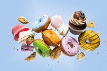 Colorful Decorated Donuts Falling In Motion On Pink Background With Sprinkling. Sweet And Various Doughnuts Flying On Pastel Backdrop. Panorama Banner