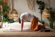Man practices yoga asana marjariasana or cow pose or cat cow pose for spine