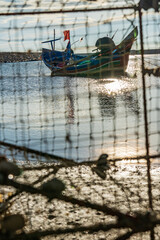 Traditional wooden fisherman boat  at a beach with blue sky in the backgroud