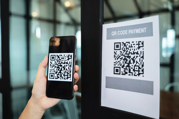 Online money, Close up hand holding smart phone for scanning Qr code for digital payment..