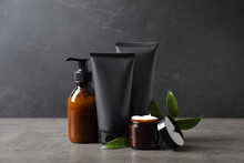 Facial Cream And Other Men's Cosmetic With Green Leaves On Grey Stone Table. Mockup For Design
