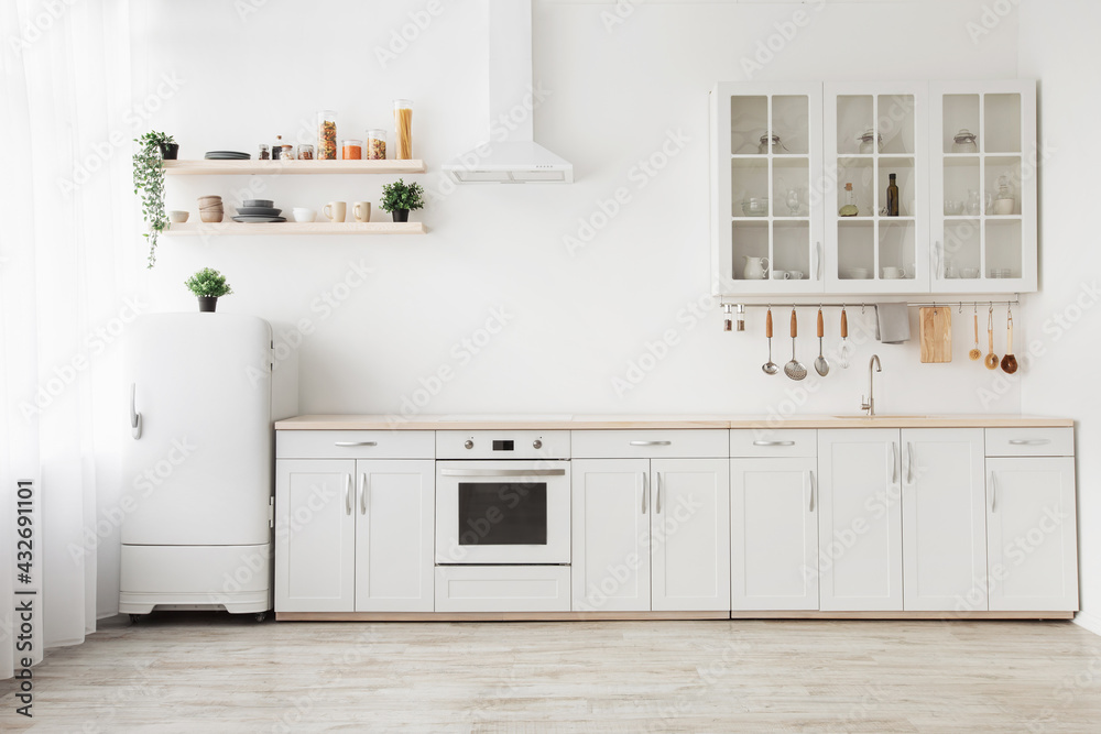 Obraz na płótnie Minimal light scandinavian kitchen interior. White furniture with utensils, shelves with crockery, small refrigerator w salonie