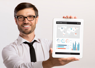 Poster - Happy businessman holding digital tablet with financial app on screen
