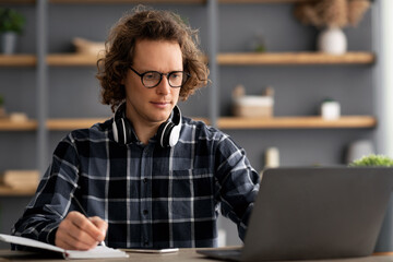 Poster - Serious Businessman Taking Notes Writing Business Report In Modern Office