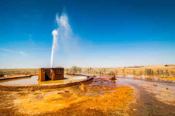 Orange mineral pool of natural water spring in Damia with stream or rising spring to the air