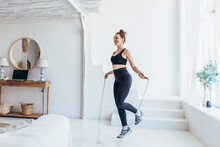 Fit Woman With Jump Rope At Home Doing Skipping Workout.